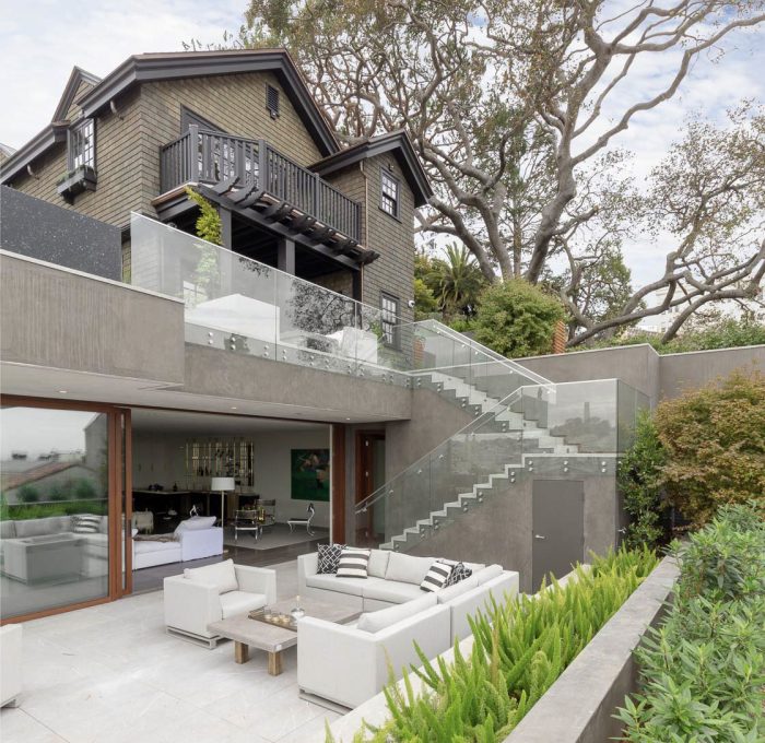 patios-surrounding-the-home-create-several-outdoor-seating-and-dining-areas-while-large-sliding-doors-allow-for-indooroutdoor-living